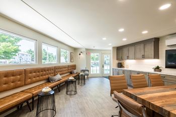 A modern kitchen with a wooden table and chairs.